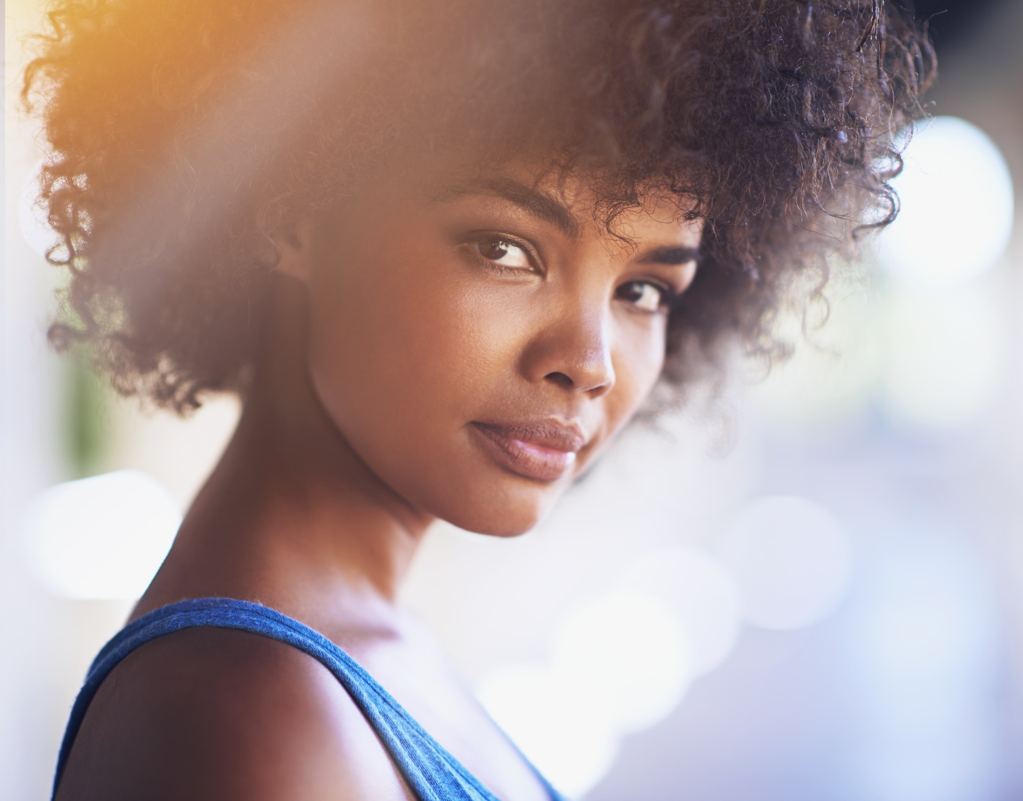 Portrait of a woman with curly hair in natural light